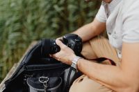 Kaboompics - Photographer holding a DSLR camera