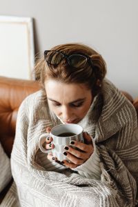 Kaboompics - Cocooning at Home: Woman Enjoying a Hot Cup of Tea