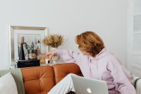 Kaboompics - Woman Reaching Beside Laptop in Home Interior