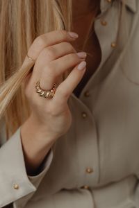 Kaboompics - Woman Showing Gold Ring Against Tan Silk Shirt