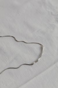 Kaboompics - Silver Chain Necklace on White Fabric