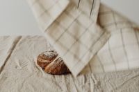 Kaboompics - Checkered Kitchen Towel Above Fresh Bread