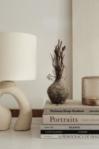 Kaboompics - Neutral Sideboard Styling with a Sculptural Lamp, Dried Vase and Design Books