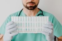 Kaboompics - Medical Professional Presenting Empty Test Tubes