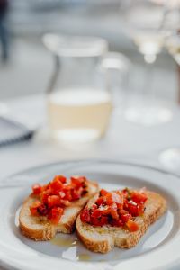 Kaboompics - Soft Focus Dining Table with Tomato Bruschetta and Wine Glass