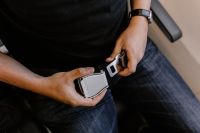 Kaboompics - Close up of man hands fasten belts while sitting on airplane seat