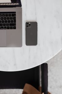Kaboompics - MacBook Pro 15 laptop and iPhone 11 Pro on a marble table