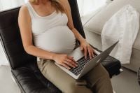 Kaboompics - Pregnant Woman Working on a Laptop in a Black Chair