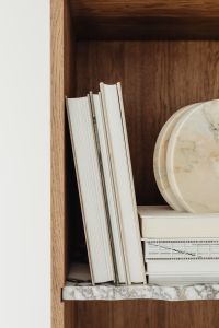 Kaboompics - White Books and a Marble Display Tray in a Walnut Bookcase