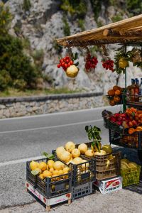 Kaboompics - Lemon and Red Grapes Hanging above a Roadside Fruit Stand