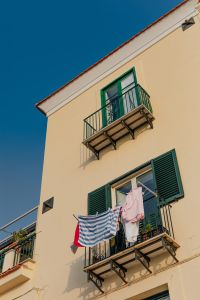 Kaboompics - Close-Up Italian Balcony with Green Shutters and Laundry in Marina di Puolo