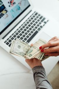 Kaboompics - Hands Counting Dollar Bills and Bitcoin Coin