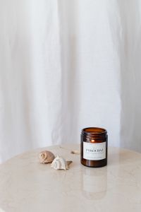 Kaboompics - Amber Candle and Seashells on Marble Table