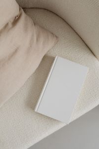 Neutral Blank Book Cover Mockups with Cream Armchair and Linen Pillow