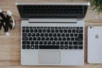 Kaboompics - Silver Acer laptop on a wooden desk with a green plant, pencils and an Apple iPhone