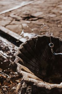 Drinking fountain with stream of water on the sidewalk
