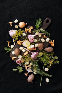 Kaboompics - Mushrooms, Garlic and Vegetables on a Dark Cutting Board