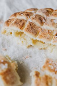 Kaboompics - Overhead View of Golden Slovenian Bread with Coarse Salt, Rustic Recipe Photography
