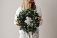 Kaboompics - Woman Holding Large Evergreen Christmas Wreath