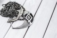 Kaboompics - Black and White Statement Necklace on White Wood with Copy Space