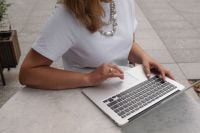 Kaboompics - Woman Working on a Laptop at an Outdoor Coffee Table