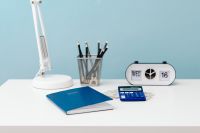 Kaboompics - Pencil Cup and Flip Calendar Against a Pale Blue Wall