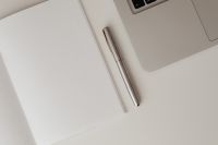 Kaboompics - Close-Up of Silver Pen on Dotted Notebook Beside Laptop