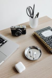 Kaboompics - Workspace with Laptop, Camera, Notebook and AirPods