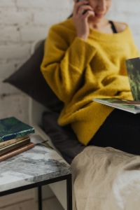 Kaboompics - At-Home Lifestyle Portrait of Woman Reading a Magazine on a Gray Sofa