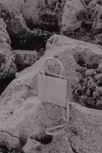 Kaboompics - White Mini Tote Bag in a Textured Limestone Setting
