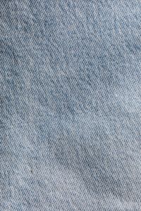 Kaboompics - Vertical Light Blue Denim Fabric Texture with Subtle Folds and Diagonal Twill