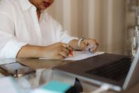 Kaboompics - Black Woman Reviewing Paperwork at Home Desk