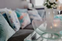 Kaboompics - Soft-Focus Blue Sofa and Cushions with Decorative Glass Bowl in Foreground