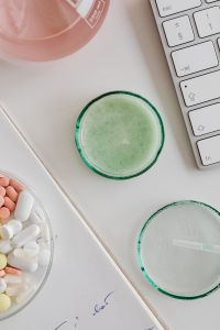 Kaboompics - Green Liquid in Petri Dish Beside Computer Keyboard