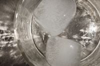 Kaboompics - Translucent Ice Cubes Floating in Clear Water, Sunlit Macro Drink Background