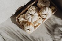 Kaboompics - White Mini Pumpkins in a Wicker Tray on White Linen