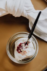 Kaboompics - Overhead Berry Yogurt Jar with Black Spoon and White Napkin