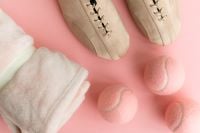 Kaboompics - Pastel Tennis Balls With Shoes And Towel On Pink Background