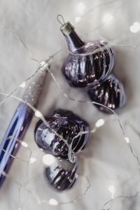 Kaboompics - Single Metallic Violet Ornament on White Fabric