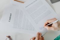 Kaboompics - Doctor Signing Medical Documents With Silver Pen
