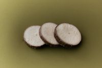 Kaboompics - Three Coconut Slices on Olive Green Background