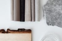 Kaboompics - Rolled Neutral Textiles with Wood and Stone Samples