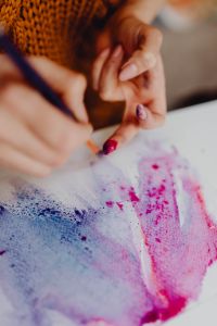 Kaboompics - A woman paints with watercolors