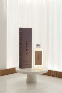Kaboompics - Fragrance Bottle and Box Against Sheer White Curtains