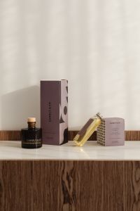 Kaboompics - Candle Jar and Fragrance Oil Set on a Wood Table