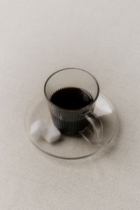 Kaboompics - Black Coffee in Ribbed Glass Cup with Sugar Cubes