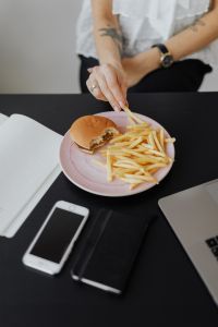 Kaboompics - Hand Reaching for Fries During Office Lunch