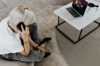 Kaboompics - Woman Talking on Phone in Bright Living Room with Laptop