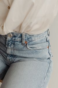 Kaboompics - Close-Up of Light Blue High-Waisted Jeans with a White Silk Blouse, Women’s Fashion Outfit