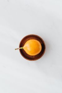 Kaboompics - Top-Down Passion Fruit and Dark Wooden Bowl on Marble for Food Blog Backgrounds